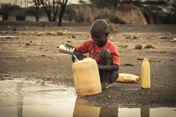child-collecting-water-2-1-scaled